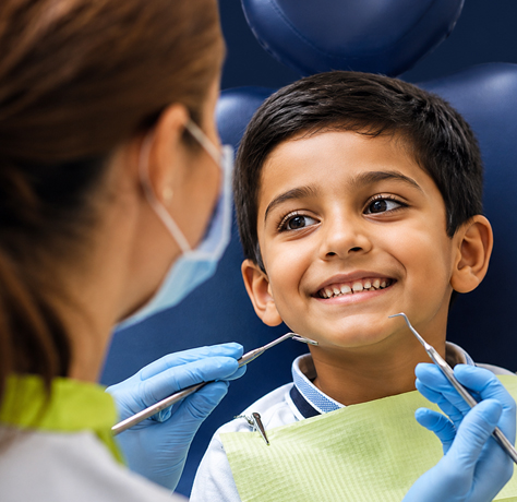 Pediatric dentist treating child in Kolhapur